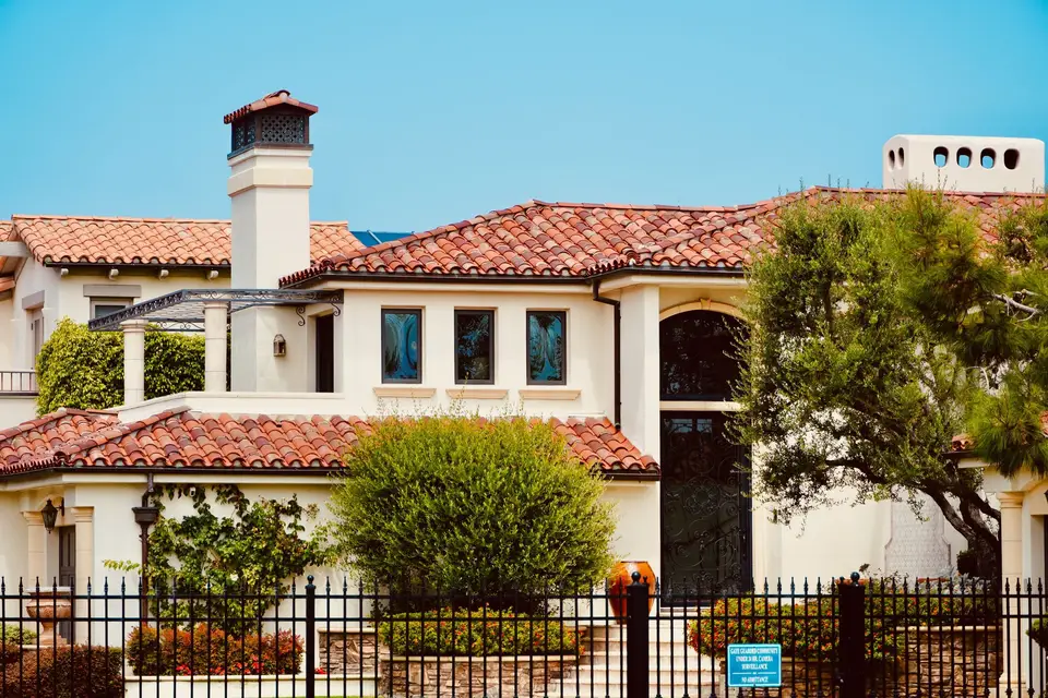 Mediterranean-style home with a red tile roof
