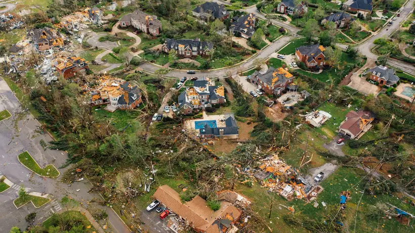 Aerial view of a neighborhood with roofs torn up by a hurricane